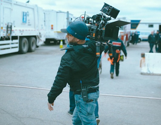 man walking with camera on shoulder - Crew Connection